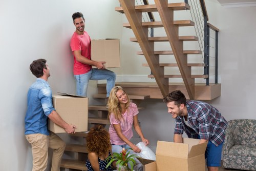 Removal team preparing a safe home move with packing and lifting equipment