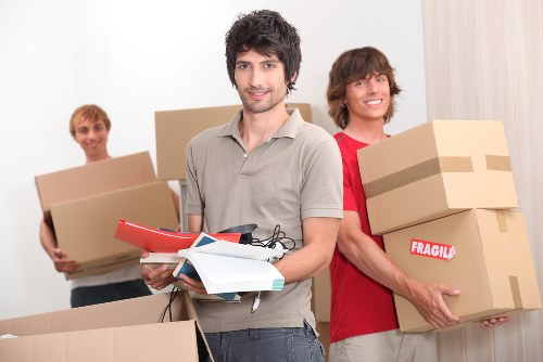 Loading household furniture into a van for an Ilford relocation