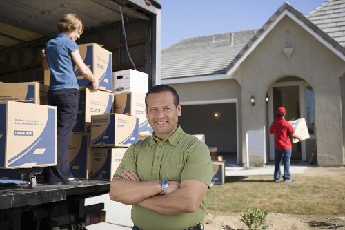 Removal team handling furniture and boxes for an Ilford home