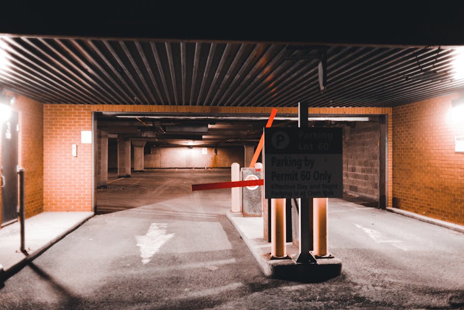 A rectangular white parking permit sign mounted on a wooden post outdoors, with a blue accessibility symbol at the top indicating space reserved for wheelchair users. Below, there is a blue parking symbol with a white 'P' and text that reads 'Blue badge holders only' in black letters. The sign is positioned against a background of a brick wall, with sunlight casting a shadow on the wall and part of the sign. This signage is relevant to house removals and furniture transport services, such as those provided by Removal Companies Ilford, which often require parking considerations for home relocation activities. The sign indicates designated parking restrictions in residential or commercial areas, reflecting the importance of planning for proper permissions and parking permits involved in the moving process, especially when space is limited or parking rules are strict.